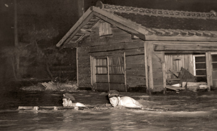 濁流にハシゴを運ぶ鉄道員 [小柳春夫, 朝日新聞報道写真傑作集 1954より] パブリックドメイン画像 