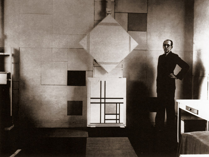 Piet Mondrian Standing in front of his Works [Piet Mondrian, c.1933, from Mondrian: 1872-1944: Structures in Space]